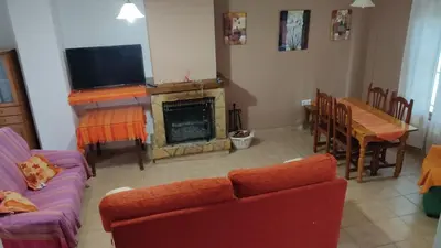 a living room with a couch and a fireplace at Casa Babuche in Algar