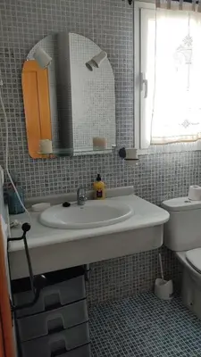 a bathroom with a sink and a toilet and a mirror at Casa Babuche in Algar