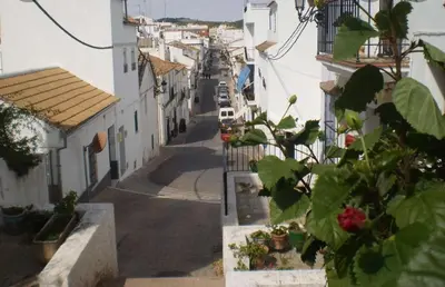 an empty street in a town with white buildings at Casa Babuche in Algar