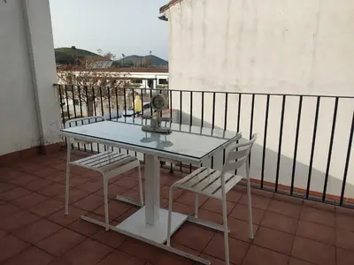 a table and two chairs on a balcony at Casa Babuche in Algar