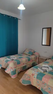 a room with two beds and a mirror at Casa Babuche in Algar