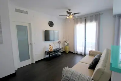 a living room with a couch and a tv at Felipe Frente al rio in Sanlúcar de Barrameda