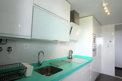 a kitchen with a sink and white cabinets at Felipe Frente al rio in Sanlúcar de Barrameda