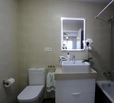 a bathroom with a sink and a toilet and a mirror at Felipe Frente al rio in Sanlúcar de Barrameda