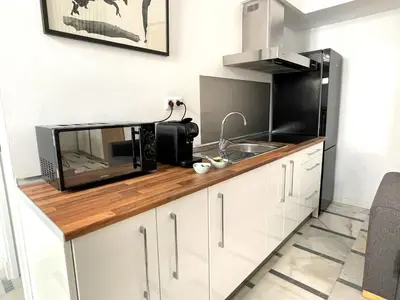 a kitchen with a microwave and a sink at No 5 Cádiz in Cádiz