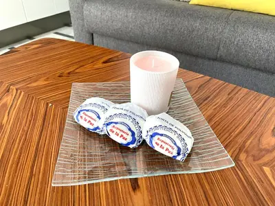 a candle and two cups on a coffee table at No 5 Cádiz in Cádiz