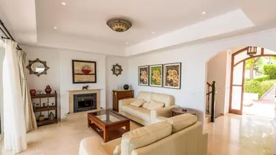 a living room with a couch and a fireplace at Villa Grazalema 1 - Villa 37 Arcos de la Frontera by Ruralidays in Arcos de la Frontera
