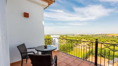 a patio with a table and chairs on a balcony at Villa Grazalema 1 - Villa 37 Arcos de la Frontera by Ruralidays in Arcos de la Frontera