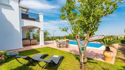 a yard with chairs and a table and a tree at Villa Grazalema 1 - Villa 37 Arcos de la Frontera by Ruralidays in Arcos de la Frontera