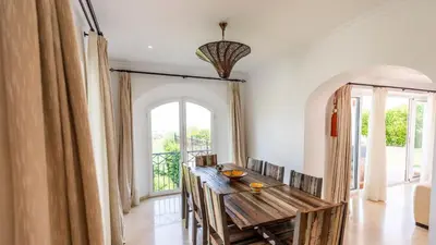 a dining room with a wooden table and a large window at Villa Grazalema 1 - Villa 37 Arcos de la Frontera by Ruralidays in Arcos de la Frontera