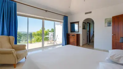 a bedroom with a bed and a large window at Villa Grazalema 2 - Villa 39 Arcos de la Frontera by Ruralidays in Arcos de la Frontera