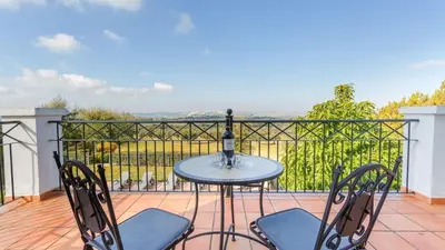 a table and chairs on a balcony with a view at Villa Grazalema 2 - Villa 39 Arcos de la Frontera by Ruralidays in Arcos de la Frontera
