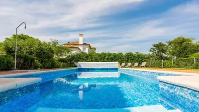 a swimming pool with blue water in front of a house at Villa Grazalema 2 - Villa 39 Arcos de la Frontera by Ruralidays in Arcos de la Frontera