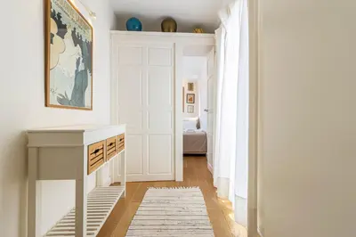 a hallway with white walls and a white door at Penthouse Arenal - Boutique Puerta Real in Jerez de la Frontera