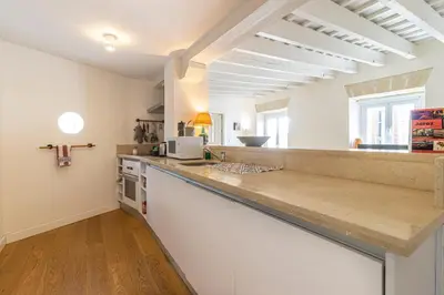a kitchen with white walls and a counter top at Penthouse Arenal - Boutique Puerta Real in Jerez de la Frontera