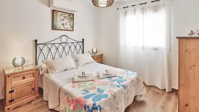 a bedroom with a bed with two pillows on it at Casa Merce Conil de la Frontera by Ruralidays in Conil de la Frontera