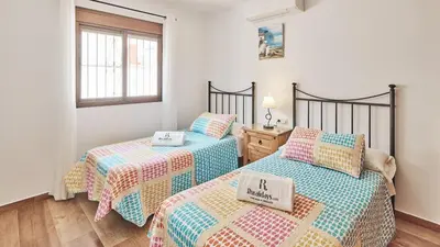 a bedroom with two beds and a window at Casa Merce Conil de la Frontera by Ruralidays in Conil de la Frontera