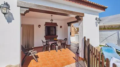 a patio with a table and chairs in a house at Casa Merce Conil de la Frontera by Ruralidays in Conil de la Frontera