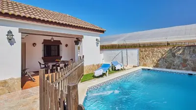 a house with a swimming pool next to a building at Casa Merce Conil de la Frontera by Ruralidays in Conil de la Frontera