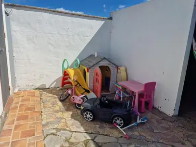 a toy car parked next to a play house at El Moral in Cádiz