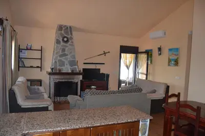 a living room with a couch and a fireplace at El Moral in Cádiz
