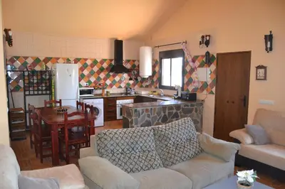 a living room with a couch and a kitchen at El Moral in Cádiz