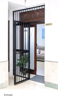 a room with a iron door with a plant in it at Apartamento Loft Puerto de Gades in Cádiz