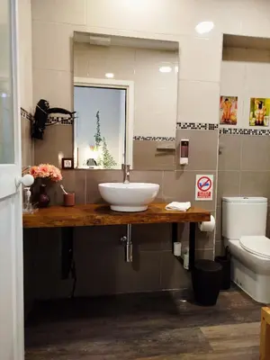 a bathroom with a sink and a toilet at Apartamento Loft Puerto de Gades in Cádiz
