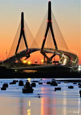 a bridge over a body of water at sunset at Apartamento Loft Puerto de Gades in Cádiz