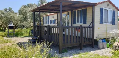 a tiny house with a porch and a gazebo at Chiclana Mobile House - Piscina , Wi-Fi, Relax in Chiclana de la Frontera