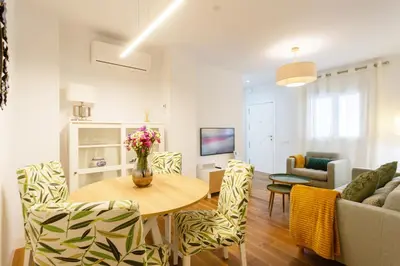 a living room with a table and chairs at El DESCANSO de San Antonio by Cadiz4Rentals in Cádiz