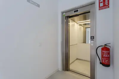 an elevator with a fire extinguisher next to a door at El DESCANSO de San Antonio by Cadiz4Rentals in Cádiz