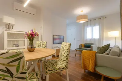 a living room with a table and chairs and a couch at El DESCANSO de San Antonio by Cadiz4Rentals in Cádiz