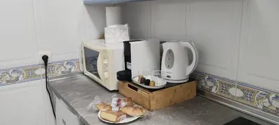 a kitchen with a bread mixer and a plate of bread at El rincón de la Caleta in Cádiz