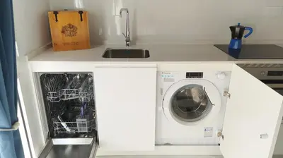 a kitchen with a washing machine in a white kitchen at Sherryflat Teatro in Jerez de la Frontera