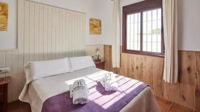 a bedroom with a bed with towels on it at Chalet El Cancelín Conil de la Frontera by Ruralidays in Conil de la Frontera