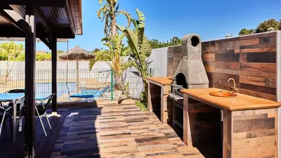 a patio with a sink and an outdoor oven at Chalet El Cancelín Conil de la Frontera by Ruralidays in Conil de la Frontera