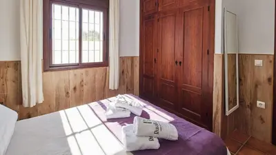 a bedroom with a bed with towels on it at Chalet El Cancelín Conil de la Frontera by Ruralidays in Conil de la Frontera