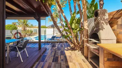a patio with a table and an outdoor oven at Chalet La Raya Conil de la Frontera by Ruralidays in Conil de la Frontera