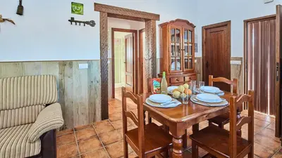 a dining room with a table and a couch at Chalet La Raya Conil de la Frontera by Ruralidays in Conil de la Frontera