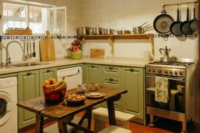 a kitchen with a table with a bowl of fruit on it at Dehesa de las Yeguas casa en finca privada con piscina y playa in Cádiz