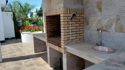 a bathroom with a brick oven with a sink at Casa La Palmera - Sólo Familias y Parejas in Conil de la Frontera