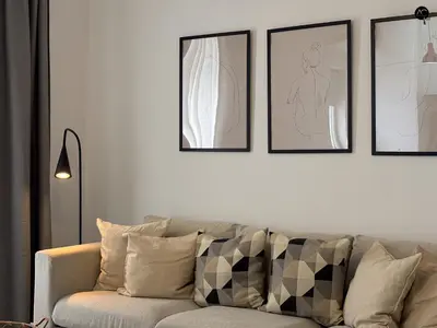 a living room with a couch and a kitchen at ARTE Playa la Caleta Grupo AC Gestion in Cádiz