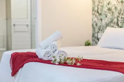 a pile of towels sitting on top of a bed at LalaSuites CORREDERA in Jerez de la Frontera