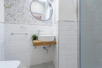 a bathroom with a sink and a mirror at LalaSuites CORREDERA in Jerez de la Frontera