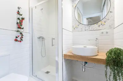 a bathroom with a shower and a sink and a mirror at LalaSuites CORREDERA in Jerez de la Frontera