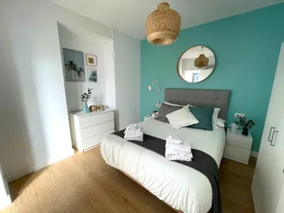 a bedroom with a bed with blue walls and a mirror at No 10 Cádiz in Cádiz
