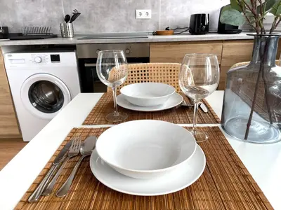 a table with a plate and two wine glasses at No 10 Cádiz in Cádiz
