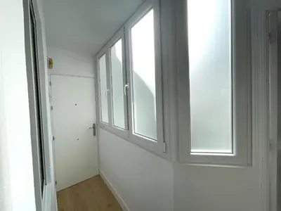 a room with two windows and a wooden floor at No 10 Cádiz in Cádiz