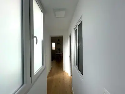 a hallway with white walls and windows in a house at No 10 Cádiz in Cádiz